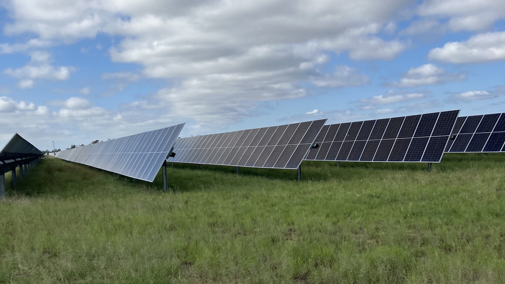 Solar panels at Edenvale Solar Park beneath a cloudy sky